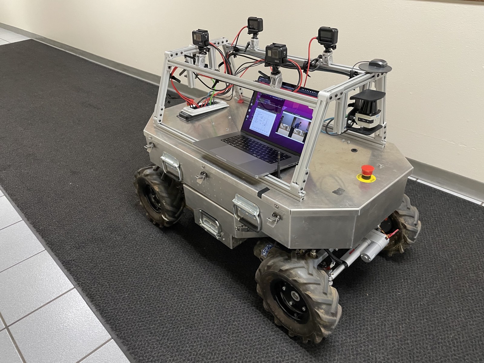 Side profile of the rover next to a screen running visualizations